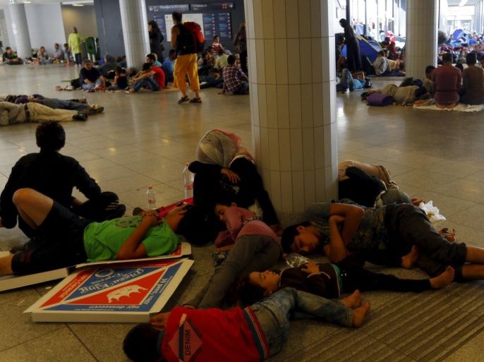 Migrants rest while waiting to leave Hungary outside a train station in Budapest, Hungary August 29, 2015. About 100,000 migrants, many of them from Syria and other conflict zones in the Middle East, have taken the Balkan route into Europe this year, heading via Serbia for Hungary and Europe's Schengen zone of passport-free travel. Most then move on to richer countries such as Austria and Germany. REUTERS/Laszlo Balogh