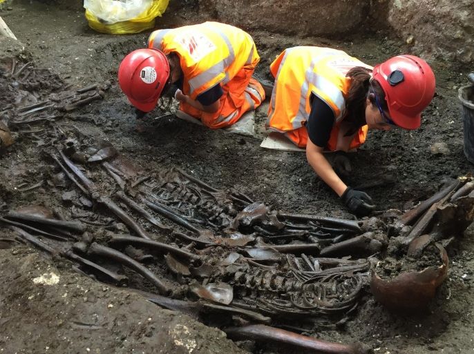 A handout photograph made available on 12 August 2015 showing archeologists working at the mass burial site suspected of containing 30 victims of The Great Plague of 1665 which has been unearthed at Crossrail's Liverpool Street site in the City of London, England 03 August 2015. The discovery was found during excavation of the Bedlam burial ground at Crossrailâs Liverpool Street site, which will allow construction of the eastern entrance of the new station. . The Crossrail route will pass through 40 stations and run from Reading and Heathrow in the west, through new twin-bore 21 km (13 miles) tunnels to Shenfield and Abbey Wood in the east. EPA/CROSSRAIL / HANDOUT