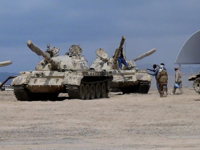 In this photo taken Tuesday, March 24, 2015, tanks seized recently by militiamen loyal to Yemen's President Abed Rabbo Mansour Hadi take positions at the al-Anad air base in the southern province of Lahej, 60 kilometers (35 miles) north of Aden, Yemen. Hadi fled the country by sea Wednesday on a boat from Aden, as Shiite rebels and their allies advanced on the southern port city of Aden, where he had taken refuge, captured his defense minister and seized the city's airport. (AP Photo/Wael Qubady)