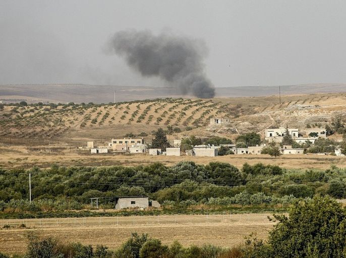 GAZIANTEP, TURKEY - JULY 28: A picture taken from Turkey shows that smoke rises over Syrian side as Turkish Army's tanks and artilleries stand guard as they are alerted, in southeastern Turkey's border city Gaziantep's Karkamis District on July 28, 2015. Turkey increase security level on the borders after a gunfire to Turkish border post from Syria across the border killed a Turkish non-commissioned officer and wounded two sergeants in Turkeys southern Kilis province. Turkish forces has been started artillery attacks and heavy air-strikes over Daesh terrorists as well as terrorist group PKK. Also, PKK had been started deadly terrorist activities inside the Turkey.