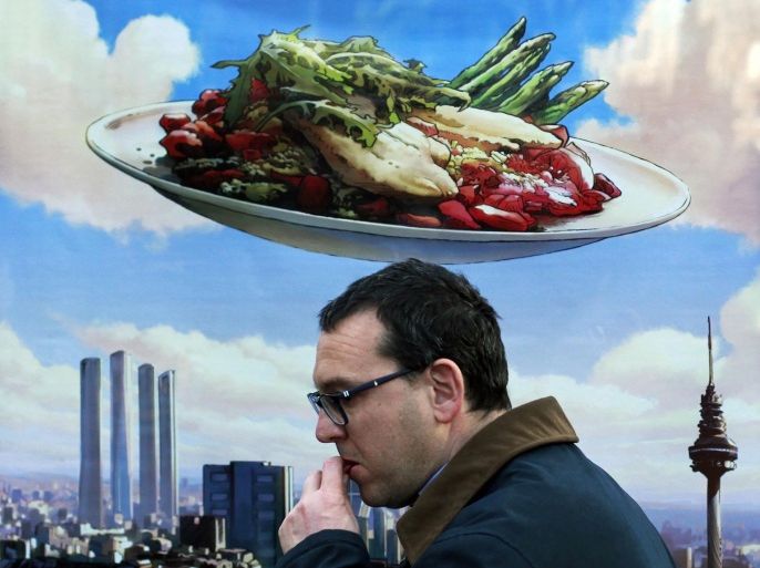 A man eats a snack as he walks by a low budget lunch promotion in Madrid, Spain, Sunday, Feb. 3, 2013. Spain's recession is worse than thought after official figures Wednesday showed the country's economy shrank 0.7 percent in the fourth quarter of 2012 from the previous three-month period.