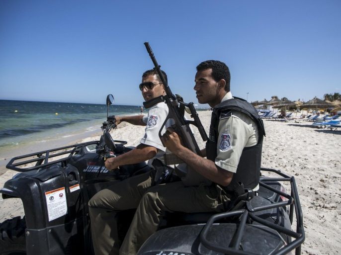 National guard members patrol at the beach near the Imperiale Marhaba hotel, which was attacked by a gunman in Sousse, Tunisia, July 1, 2015. Hundreds of armed police patrolled the streets of Tunisia's beach resorts on Sunday and the government said it will deploy hundreds more inside hotels after the Islamist militant attack in Sousse that killed 39 foreigners, mostly Britons. REUTERS/Zohra Bensemra