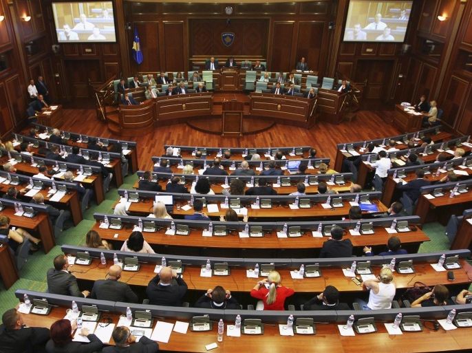 Kosovar Members of Parliament sit in the Assembly during a summer session in Pristina, August 3, 2015. Kosovo's parliament voted to change the constitution on Monday and create a war crimes court, which the West wants to try ethnic Albanian former guerrillas for alleged war crimes including organ harvesting. The constitutional changes were endorsed by 82 deputies in the 120-seat parliament. REUTERS/Hazir Reka