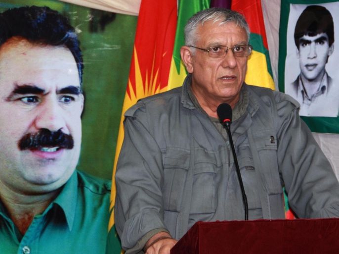 An undated picture made avaliable 11 August 2015 shows Cemil Bayik, one of the five founders of the Kurdistan Workers' Party (PKK), standing in front of a picture of the spiritual leader, Abdullah Öcalan, during an interview, in the Qandil Mountains, Iraq. According to local reports 10 August 2015, Bayik has accused Turkey of protecting the group calling themselves Islamic State (IS) as airstrikes disproportionately target the PKK and not IS. Turkey has resumed airstrikes against PKK positions in both Turkey and Northern Iraq, following a number of attacks throughout Turkey as peace talks between AKP and the PKK broke down.