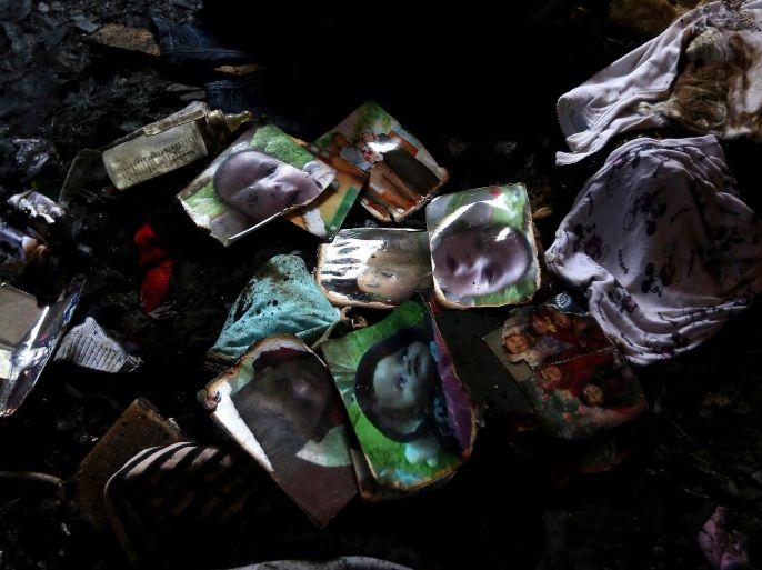 NABLUS, WEST BANK - JULY 31: Pictures of the killed baby are seen as officials carry out crime scene investigation in the building burnt out when Jewish residents of the village of Duma in the northern West Bank district of Nablus set fire to the house of a Palestinian family, killing a baby, on July 31, 2015.