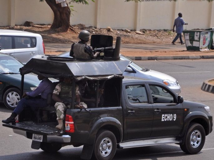 Nigerian troops patrol with a vehicle in the city of Abuja, Nigeria, Saturday, Feb. 7, 2015. Nigeria is postponing presidential and legislative elections until March 28 because security forces fighting Boko Haram extremists cannot ensure voters' safety around the country, the electoral commission announced Saturday in a decision likely to infuriate the opposition. (AP Photo/Olamikan Gbemiga)