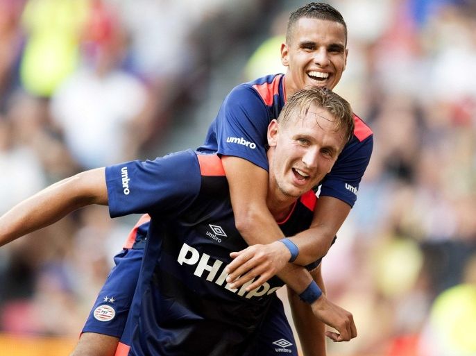 PSV Eindhoven players Luuk de Jong (bottom) and Adam Maher celebrate Maher's 3-0 during the Dutch super cup match between the league champion (PSV) and the national cup winner (FC Groningen), in Amsterdam, Netherlands, 02 August 2015.
