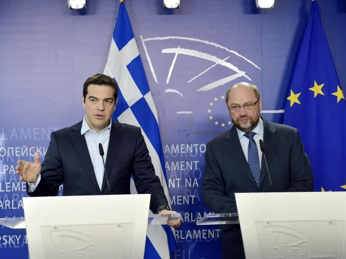 Greek Prime Minister Alexis Tsipras (L) gives a statement with Martin Schulz, President of the European Parliament, at the European Parliament in Brussels, March 13, 2015. Greece's problems are euro zone's problems and the single currency area should send Greece a message of solidarity as Athens stands ready to deliver on promises to reform in exchange for more loans, Tsipras said. "Greece has already started fulfilling its commitments mentioned in the Eurogroup decision of 20 Feb so we are doing our part and we expect our partners to do their own," Tsipras told reporters after meeting Schulz. REUTERS/Eric Vidal (BELGIUM - Tags: POLITICS)