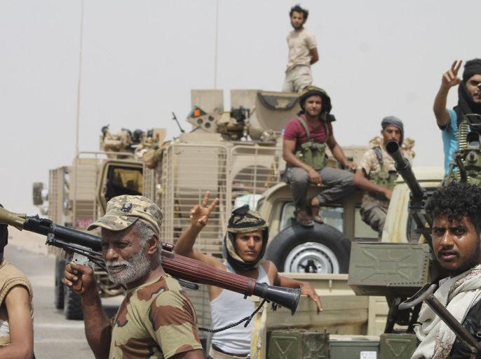 In this photo taken Monday, Aug. 3, 2015, fighters against Shiite rebels known as Houthis gather at the road leading to Al-Anad base near Aden in the southern province of Lahej, Yemen. The capture of the Al-Anad base was a significant victory for the forces allied to Yemen's exiled President Abed Rabbo Mansour Hadi in their battle to reverse the gains of Houthis. (AP Photo/Wael Qubady)