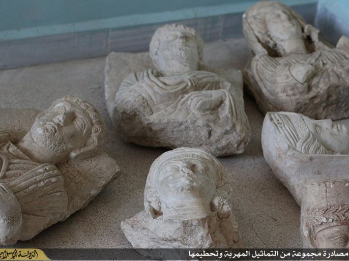 This image posted on a militant website by the Aleppo branch of the Islamic State group on Friday, July 3, 2015, which has been verified and is consistent with other AP reporting, shows items that the group claims are six smuggled archaeological pieces from the historic central town of Palmyra. An IS statement says the busts were found when the smuggler was stopped at a checkpoint and was later referred to an Islamic which ordered that they be destroyed and the man be whipped. Arabic on the caption reads, “a collection of smuggled statues was destroyed." (militant website via AP)