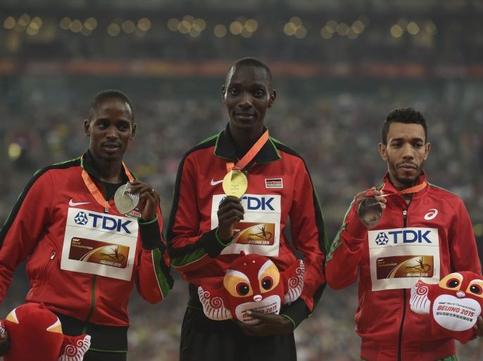 TLR002 - Beijing, -, CHINA : (L-R) Kenya's silver medallist Elijah Motonei Manangoi, Kenya's gold medallist Asbel Kiprop and Morocco's bronze medallist Abdalaati Iguider pose with their medals on the podium during the victory ceremony for the men's 1500 metres athletics event at the 2015 IAAF World Championships at the "Bird's Nest" National Stadium in Beijing on August 30, 2015. AFP PHOTO / GREG BAKER
