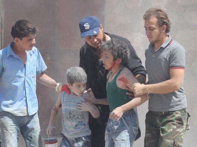 ALEPPO, SYRIA - JULY 5: Syrian children wounded after Assad regime forces air attack to Etarib district of Aleppo, Syria, on July 5, 2015.