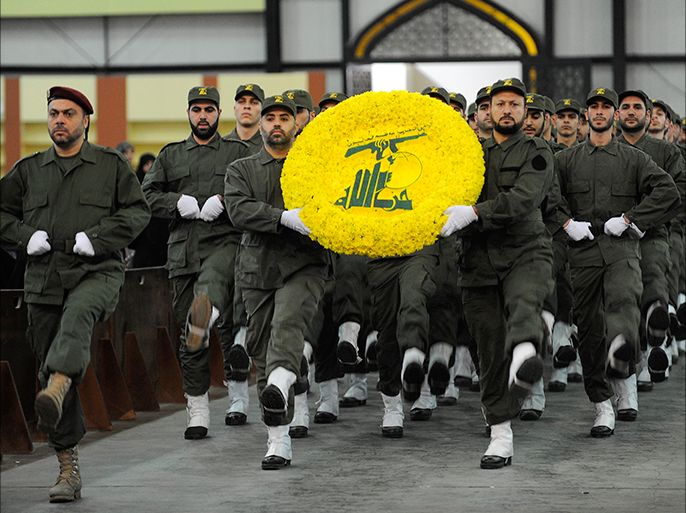 epa03000036 Hezbollah militants carry a flower wreath in the colors of the Shiite Muslim group's logo during a rally marking Hezbollah Martyrs' Day at the southern suburbs Beirut, Lebanon, 11 November 2011. According to local media, Hezbollah leader Hassan Nasrallah delivered a speech touching the issue of financing the Special Tribunal for Lebanon, the situation in Syria and the latest developments in the Middle East, especially the Iranian nuclear program and tension with the Western countries. EPA/WAEL HAMZEH