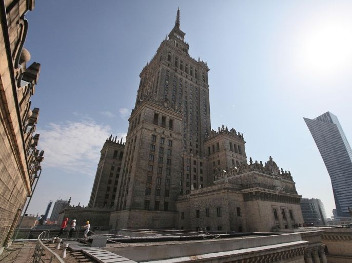 In this July 18, 2015 photo, visitors stand on a terrace of the Palace of Culture and Science, center, next to the so-called “sail”, a modern highrise skyscraper by U.S. architect Daniel Liebeskind, right, in Warsaw, Poland. The Palace of Culture was an unwanted gift from Soviet leader Josef Stalin in 1955 and recently celebrated its 60th birthday. It has survived repeated calls to be torn down as a symbol of communist-era oppression. (AP Photo/Czarek Sokolowski)