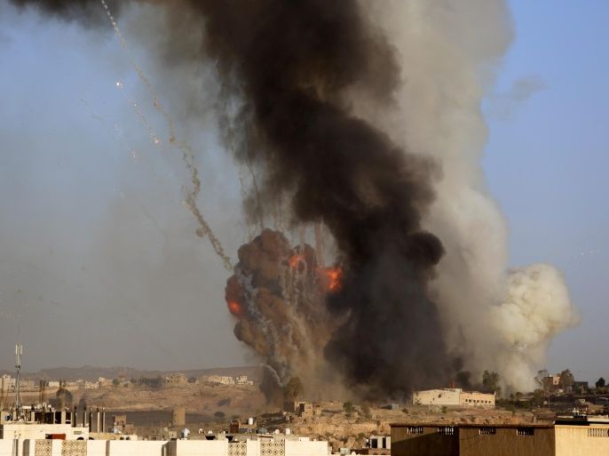 An explosion and smoke rise after an airstrike by the Saudi-led coalition at a weapons depot in Sanaa, Yemen, Friday, Sept. 11, 2015. Saudi Arabia is leading a coalition of mainly Gulf nations fighting the Houthis, who seized the capital, Sanaa, last September. (AP Photo/Hani Mohammed)