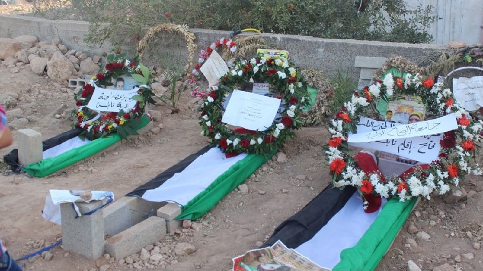 ‪القوى الوطنية حرصت على زيارة مقابر شهداء عائلة دوابشة في عيد الأضحى‬ (الجزيرة)