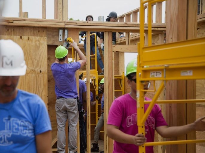 New York City College of Technology (CUNY) undergraduate students work on a house for the U.S. Department of Energy Solar Decathlon 2015 in the Brooklyn borough of New York, U.S., on Wednesday, July 8, 2015. The U.S. Department of Labor is scheduled to release initial jobless claims figures on July 9.