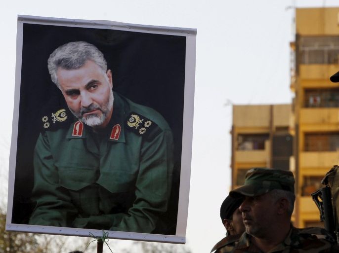 Members from Hashid Shaabi hold a portrait of Quds Force Commander Major General Qassem Suleimani during a demonstration to show support for Yemen's Shi'ite Houthis and in protest of an air campaign in Yemen by a Saudi-led coalition, in Baghdad March 31, 2015. Saudi troops clashed with Yemeni Houthi fighters on Tuesday in the heaviest exchange of cross-border fire since the start of a Saudi-led air offensive last week, while Yemen's foreign minister called for a rapid Arab intervention on the ground. REUTERS/Thaier Al-Sudani