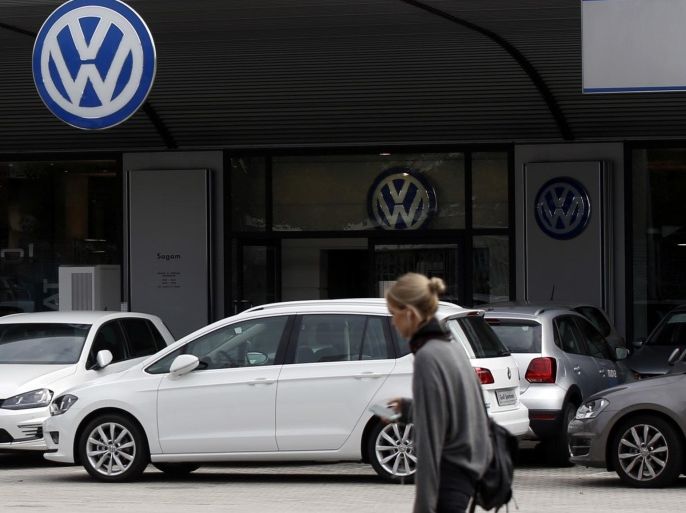 A woman walks by a Volkswagen dealer in Milan, Italy, Sunday, Sept. 27, 2015. German media report that Volkswagen received warnings years ago about the use of illegal tricks to defeat emissions tests. The automaker admitted last week that it used special software to fool U.S. emissions tests for its diesel vehicles. (AP Photo/Luca Bruno)