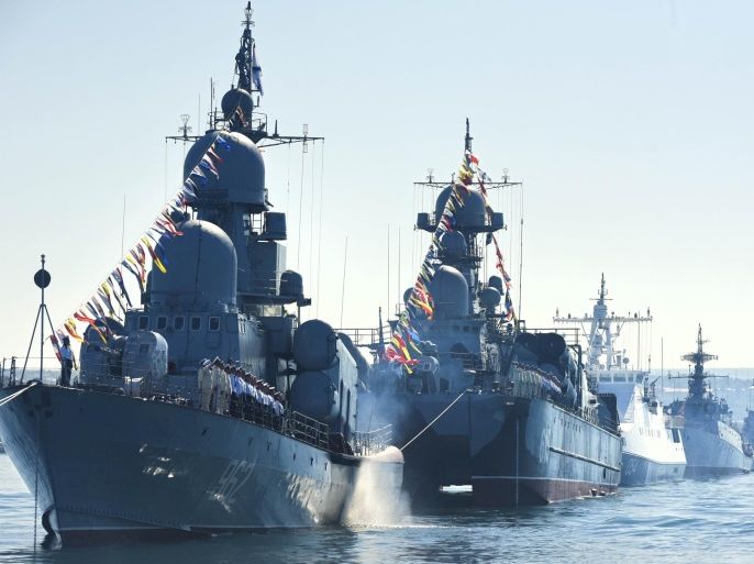Russian navy battle ships station in the bay during a rehearsal of the Russian Navy Day parade in Sevastopol, Crimea, Friday, July 24, 2015. The Russian Navy Day is celebrated the last Sunday of July. (AP Photo/Alexander Polegenko)