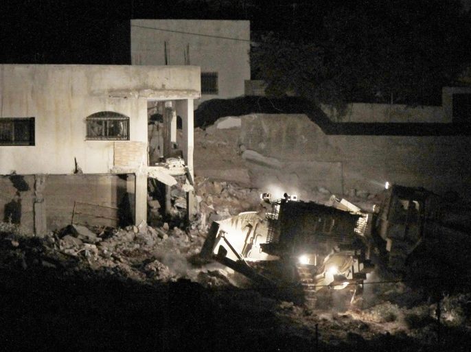 Israeli Army bulldozers demolishes a two storey bullding of Majdi Abu Al Hayja which followed an army operation at the Jenin refugee camp, in the West Bank, 01 September 2015. According to reports a gun battle erupted late 31 August 2015 during a large-scale Israeli arrest raid in the camp, reportedly to arrest a senior Islamic Jihad official, An Israeli soldier was injured in the gun battle security sources and locals said.