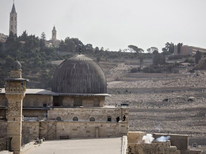 Israeli border police are seen inside the Al Aqsa Mosque compound after firing teargas or a smoke grenade in Jerusalem's Old City, Sunday, Sep. 13, 2015. Israeli police say they have restored calm around Jerusalem’s most sensitive holy site after early-morning clashes with Palestinian protesters. The hilltop compound is revered by Jews as the Temple Mount, site of the two biblical Jewish temples. Muslims call the site the Noble Sanctuary and revere it as the spot where the Prophet Muhammad ascended to heaven. (AP Photo/Tsafrir Abayov)