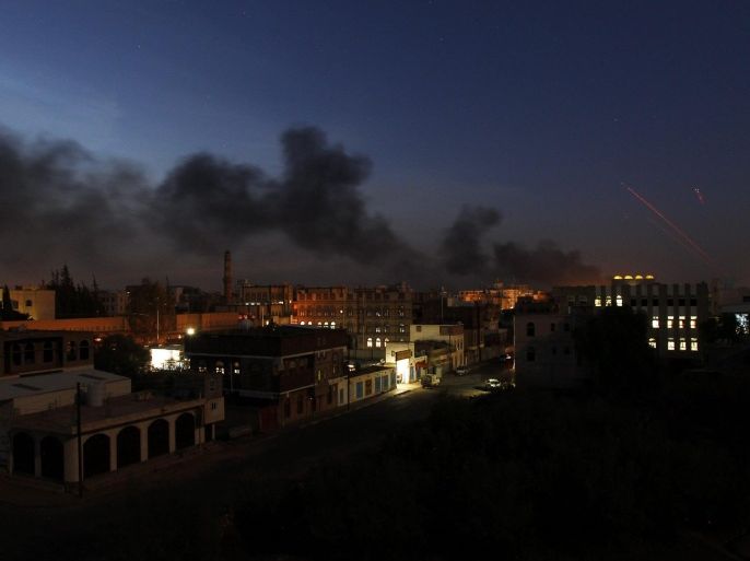 Smoke drifts through the air as sparks fly from an airstrikes carried out by the Saudi-led coalition on a Houthi-held military base in Sana'a, Yemen, 26 September 2015. According to reports, the Saudi-led coalition has continued to carry out airstrikes on the impoverished Arab nation despite Eid al-Adha.