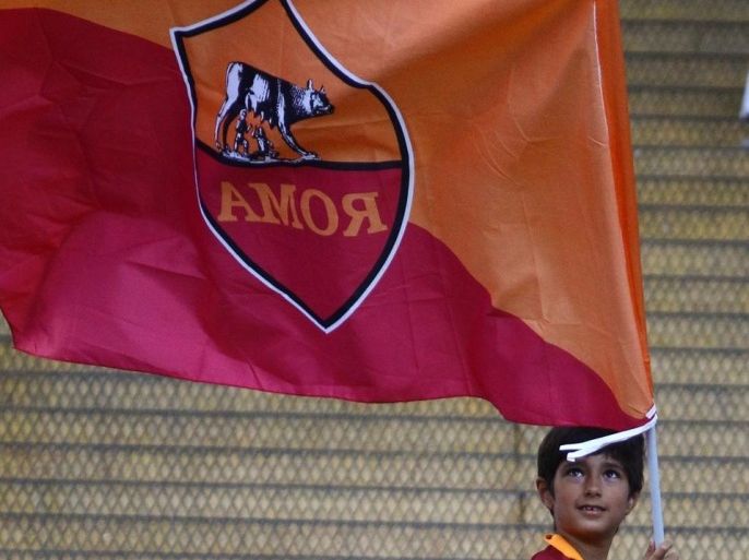 ROME, ITALY - AUGUST 19: A fan kid of Roma flies the team's flag prior to the friendly football match between AS Roma and Fenerbahce, on August 19, 2014 at the Olympic Stadium in Rome, Italy.
