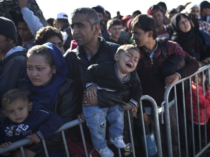 A child cries as his family wait in line in order to get into a reception center for migrants and refugees in Opatovac, Croatia, Wednesday, Sept. 23, 2015. Deeply divided European Union ministers agreed Tuesday to relocate 120,000 asylum-seekers to ease the strain on Greece and Italy, which are on the front line of the migrant flood. (AP Photo/Marko Drobnjakovic)