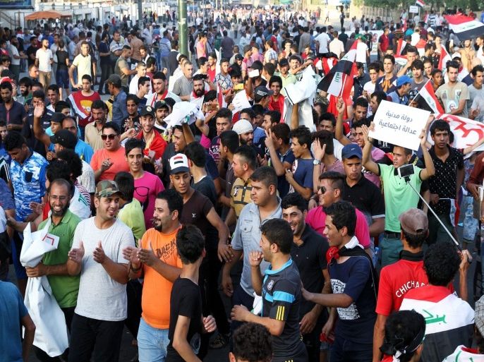 Iraqis shout slogans and carry national flags during a demonstration in Tahrir square, central Baghdad, Iraq, 04 September 2015. According to media reports thousands of Iraqis protesters continue to hold protests in Baghdad and other provinces demanding implementation of wide reforms offered by Prime Minister Haider al-Abadi, aimed at reforming the political system in attempts to eliminate widespread graft, and improve public services.