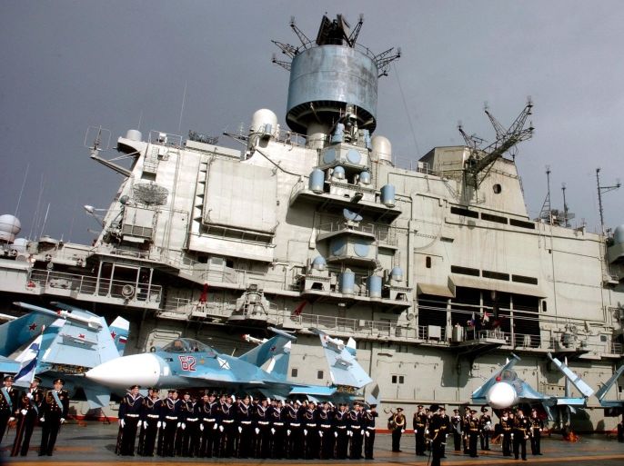A handout photo released by the official Syrian Arab News Agency (SANA) showing crew lined up aboard Russian aircraft carrier Kuznetsov in the sea port city of Tartous in Syria on 08 January 2012. A Russian flotilla has docked at the Syrian port of Tartus in a show of solidarity with the regime of President Bashar al-Assad, Syrian state media reported. The flotilla is to stay for six days at the port, according to the report. EPA/SANA