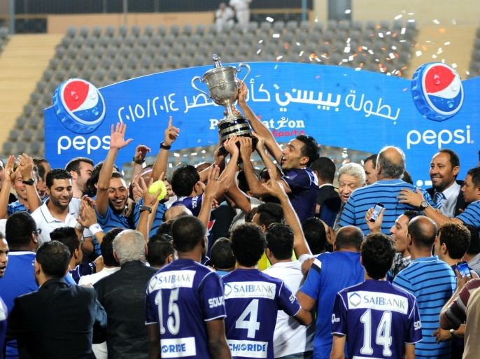 Zamalek's Mahmoud Kahraba, center, and his teammates raise the cup after winning their Egyptian Cup soccer match against Al Ahly at the Petrosport Stadium in Cairo, Egypt, Monday, Sept. 21, 2015. (AP Photo/Ahmed Gamil)