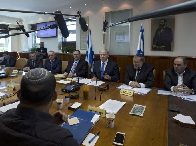 Israeli Prime Minister Benjamin Netanyahu (C) attends the weekly cabinet meeting in his Jerusalem 20 September 2015. Netanyahu was considering increasing penalties on stone throwers following clashes over the past days between stone-throwing Palestinian youths and Israeli security forces following afternoon Islamic prayers, amid rising tension over a contested holy site in Jerusalem. The violence came as Israel placed restrictions on Muslim males wishing to pray at the al-Aqsa mosque, only letting in men over the age of 40. Palestinians have voiced concern about recent changes at holy sites in the city, as right-wing Israeli political leaders have pressed for more access to the Temple Mount area, where the al-Aqsa mosque is also located.