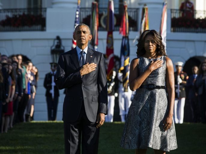 US President Barack Obama (L) and First Lady Michelle Obama (R) walk onto the South Lawn prior to a moment of silence in memory of those lost in the 9/11 terror attacks, at the White House in Washington, DC, USA 11 September 2015. The moment marks 14 years since terrorists hijacked airplanes and flew them into the twin towers in New York City and the Pentagon in Virginia, killing nearly 3,000 people.