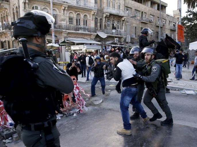 Israeli border police detain a protester during a demonstration outside the Damascus Gate in Jerusalem's Old City marking "Land Day" March 30, 2015. Land Day commemorates the killing of six Arab citizens of Israel by security forces during protests in 1976 over government land confiscations. Two protesters were detained for being involved in disturbances and were later released, an Israeli police spokesman said on Monday. REUTERS/Baz Ratner