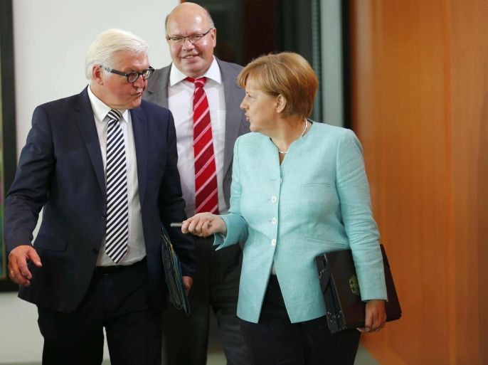 German Chancellor Angela Merkel, Foreign Minister Frank-Walter Steinmeier (L) and Head of the Federal Chancellery Peter Altmaier (C) arrivee for the weekly cabinet meeting at the Chancellery in Berlin, Germany, September 2, 2015. REUTERS/Hannibal Hanschke