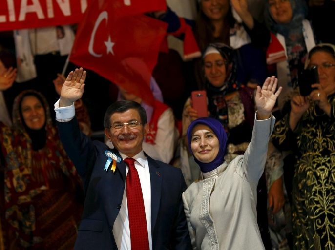 Turkish Prime Minister Ahmet Davutoglu and his wife Sare greet their supporters as they arrive to the 5th AK Party (AKP) Congress in Ankara, Turkey, September 12, 2015. When Turkey's ruling AK Party convenes its three-yearly congress in the capital Ankara on Saturday, the longest shadow will be cast by a politician who, officially at least, is no longer even a member: President Tayyip Erdogan. The friction between Erdogan and the man who replaced him as head of the AKP, Davutoglu, is likely to play out on Saturday as both men attempt to stack the party's committees with their own loyalists. REUTERS/Umit Bektas