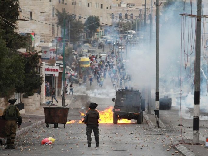 An Israeli army jeep is hit by a molotov cocktail thrown by Palestinian protesters during clashes with Palestinian protesters in the West Bank city of Bethlehem October 23, 2015. Palestinian factions called for mass rallies against Israel in the occupied West Bank and East Jerusalem in a "day of rage" on Friday, as world and regional powers pressed on with talks to try to end more than three weeks of bloodshed. REUTERS/Abdelrahman Younis