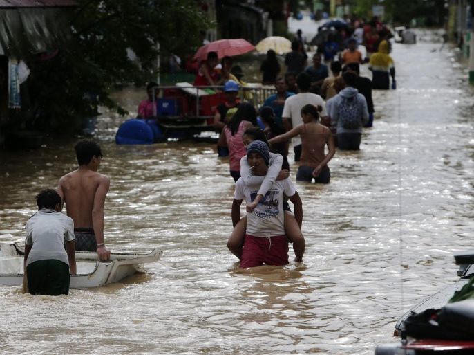 Filipino typhoon victims wade on flood water in Cabanatuan city, northern Manila, Philippines, 19 October 2015. Typhoon Koppu triggered flash floods and landslides in the northern Philippines killing at least four people and forcing thousands of people to flee their homes, officials said. Two people drowned in the province of Nueva Ecija, according to Governor Aurelio Umali, while one person was electrocuted in Tarlac province and a 14-year-old boy was hit by a falling tree in Manila, disaster relief officials said. The Philippines is hit by an average of 20 cyclones every year, causing floods, landslides and other accidents. The strongest typhoon - Haiyan - hit the country in November 2013, killing more than 6,300 people. Haiyan also displaced more than four million people after it wiped out entire villages in the central Philippines.