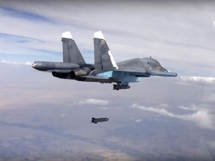 FILE - In this file photo made from the footage taken from Russian Defense Ministry official website on Friday, Oct. 9, 2015, a bomb is released from Russian Su-34 strike fighter in Syria. Hundreds of Iranian troops are being deployed in northern and central Syria, dramatically escalating Tehran’s involvement in the civil war as they join allied Hezbollah fighters in an ambitious offensive to wrest key areas from rebels amid Russian airstrikes. (Russian Defense Ministry Press Service via AP, File)