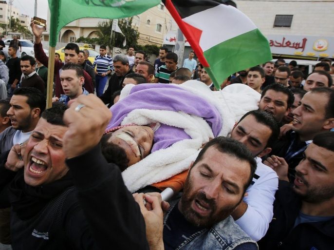 Palestinians carrying the body of 17-years old Mohammad Jabari during his funeral in the West Bank city of Hebron, 10 October 2015. Jabari was shot dead after stabbing an Israeli police officer in Kiryat Arba, a settlement near Hebron, on 09 October. Violence has been ongoing for weeks, focused on Jerusalem and nearby areas on the West Bank amid rising concerns the situation could lead to an even greater escalation if not scaled back soon.