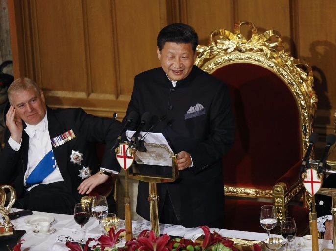 Chinese President Xi Jinping, centre, makes a speech listened to by The Duke of York, left, and The Lord Mayor of London Alan Yarrow, right, during a banquet at the Guildhall in London, Wednesday, Oct. 21, 2015. Chinese President Xi Jinping arrived in Britain Monday for a four-day State Visit as part of a push to increase trade ties between the two countries. (AP Photo/Kirsty Wigglesworth)