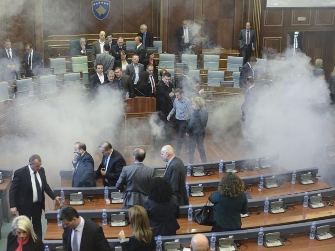 Opposition lawmakers throw tear gas during a session of Kosovo's parliament in Pristina, Kosovo 15 October 2015. Kosovo's opposition political parties protest against the agreements that has been reached during the EU-brokered dialogue with Serbia.
