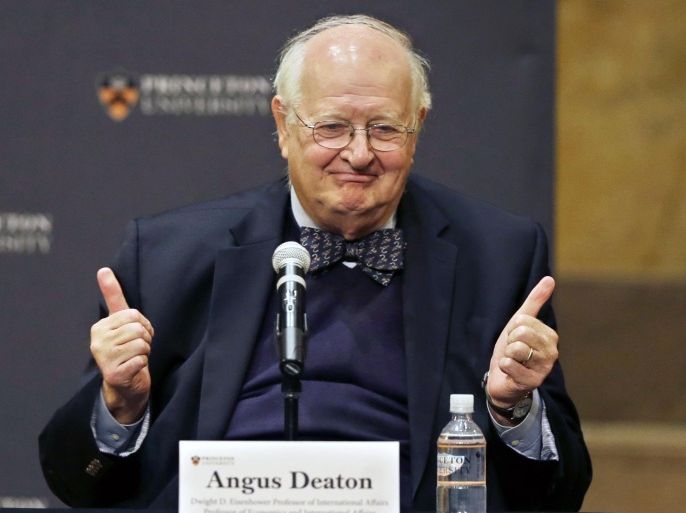 Angus Deaton gestures at a gathering at Princeton University after it was announced that he won the Nobel prize in economics for improving understanding of poverty and how people in poor countries respond to changes in economic policy, Monday, Oct. 12, 2015, in Princeton, N.J. Deaton, 69, won the 8 million Swedish kronor (about $975,000) prize from the Royal Swedish Academy of Sciences for work that the award committee said has had "immense importance for human welfare, not least in poor countries." (AP Photo/Mel Evans)