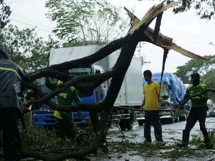 Filipinos remove toppled a tree at a high-way in the town Talavera, Nueva Ecija province, northern Manila, Philippines, 18 October 2015. Typhoon Koppu slammed into the northern Philippines forcing thousands of people to flee their homes amid heavy rains and strong winds that could last up to three days, the disaster relief agency said. Koppu toppled trees and ripped off rooftops, while nearly 10,000 people evacuated their homes amid warnings of flash floods and storm surges up to three metres.