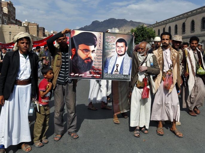 Houthi supporters hold a poster of the Lebanese Hezbollah leader, Hassan Nasrallah (L), and Houthi leader, Abdul-Malik al-Houthi (R), during a rally protesting Saudi-led military operations against positions held by the Houthis and their allies, in Sanaa, Yemen, 24 August 2015. According to local reports thousands of Houthi supporters have once again taken to the streets of Sana'a to protest ground and air operations carried out by a Saudi led coalition which have bolstered anti-Houthi groups leading to fierce clashes and the reversal of gains made by the Houthis in the south and centre of the impoverished nation now facing a looming humanitarian crisis as a direct result of the prolonged fighting of which civilians are the main victims.
