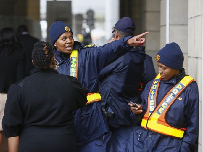A South African police woman directs a delegate outside the Cape Town International Convention Centre during the World Economic Forum on Africa, in Cape Town, South Africa, 03 June 2015. The World Economic Forum on Africa in 2015 marks 25 years of change on the continent. According to the World Economic Forum (WEF), over the past fifteen years Africa has demonstrated an economic turnaround growing two to three percentage points faster than global GDP. Some of the highlight discussions at this years meeting will focus on food security and agriculture and also the various options and areas of investment.