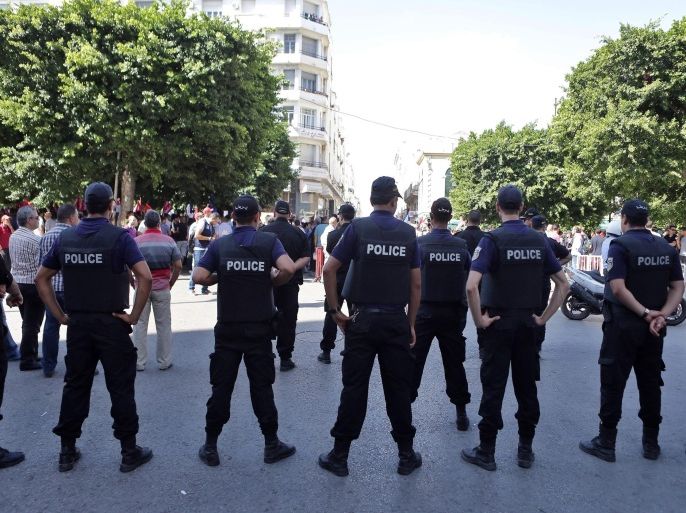 Members of the Tunisian security services stand guard during a rally called by the opposition against the economic reconciliation bill, in Tunis, Tunisia, 12 September 2015. According to local reports the draft economic and financial reconciliation law submitted by the Tunisian President, Beji Caid Essebsi, has divided Tunisians, with a majority concerned that pardoning corrupt officials from the previous regime will encourage graft and lose Tunisia millions in stolen money, however the majority Government is firmly in favor of passing the bill.