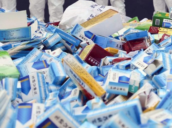 This picture taken on March 14 shows health workers preparing to destroy fake medicines seized in Beijing in recent months. The rapid growth of Internet commerce has led to an explosion of counterfeit drugs sold around the world, with China the biggest source of fake medicines, pharmaceutical experts said as the illicit trade is now believed to be worth around 75 billion USD globally, with criminal gangs increasingly using the web to move their products across borders.