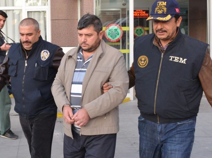 Turkish policemen escort an unidentified 'Islamic State' (IS) suspect in Konya, Turkey 27 October 2015. Media reports state that Turkish police arrested 30 Islamic State suspects during simultaneous operations against IS cell houses in the Anatolian city of Konya.